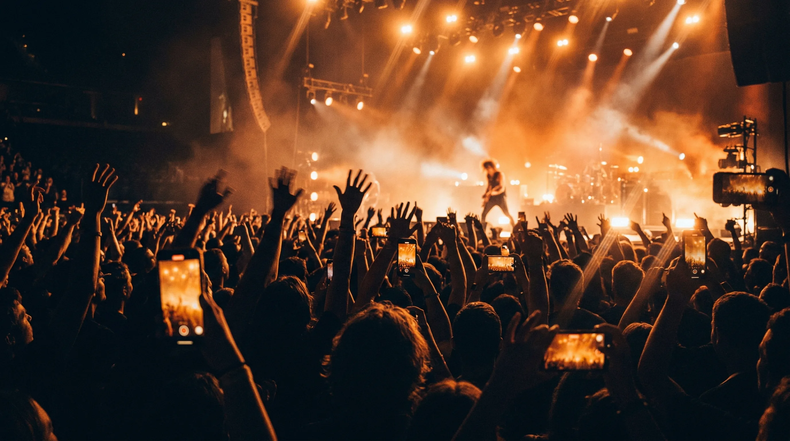 Live concert crowd under warm stage lighting
