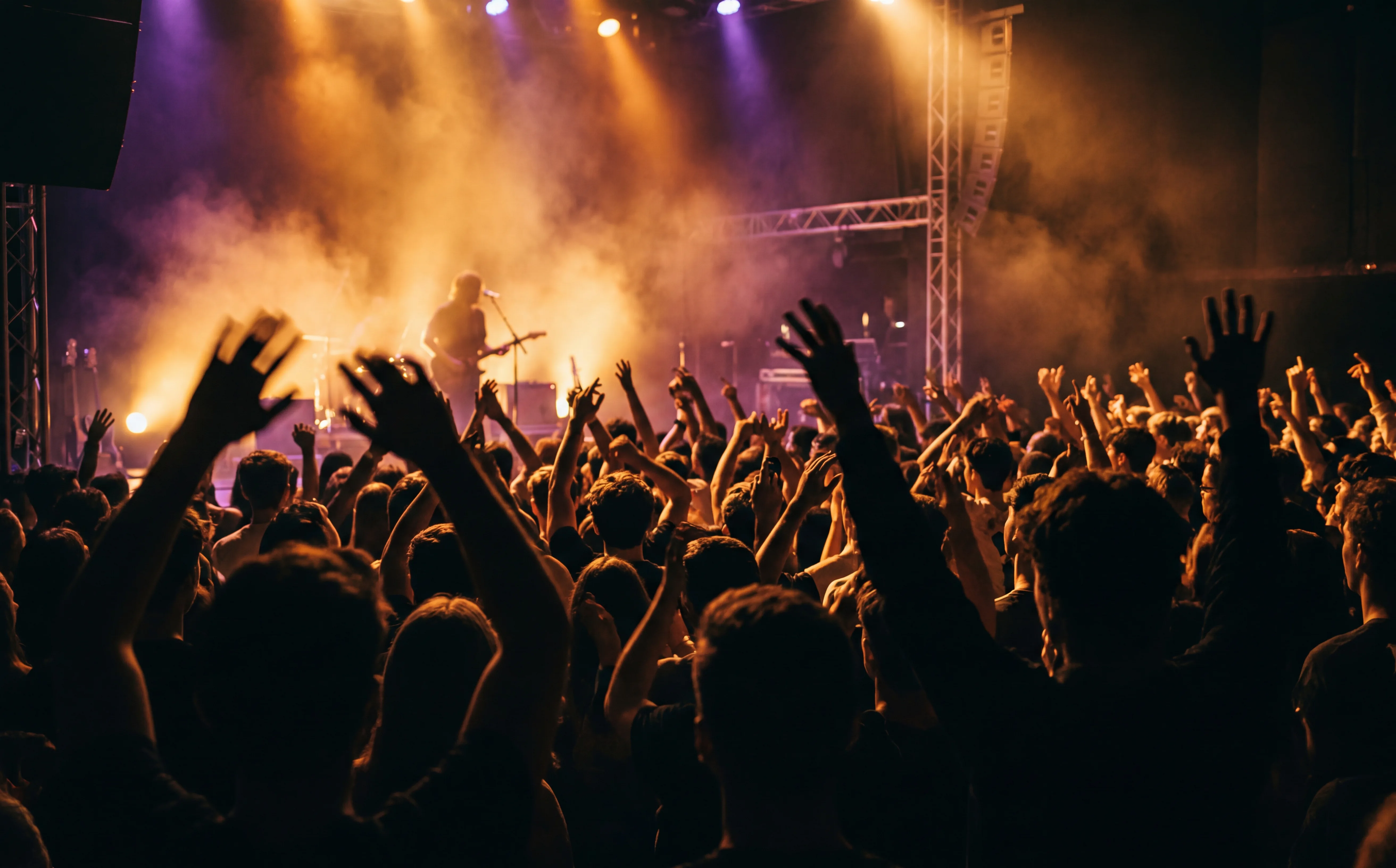 Concert crowd enjoying live music with warm stage lights